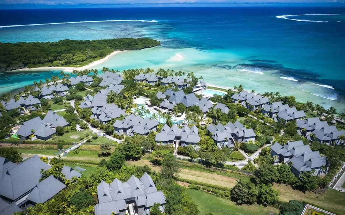 Fiji resort buildings beside a lagoon and offshore reef