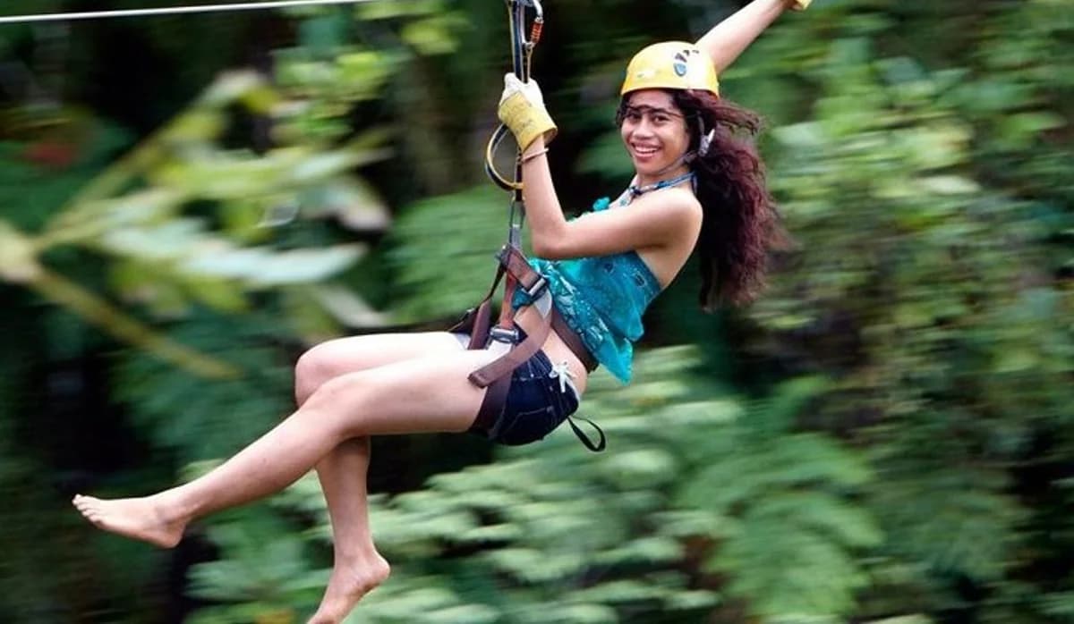 A traveller zip-lining through rainforest near Nadi in Fiji